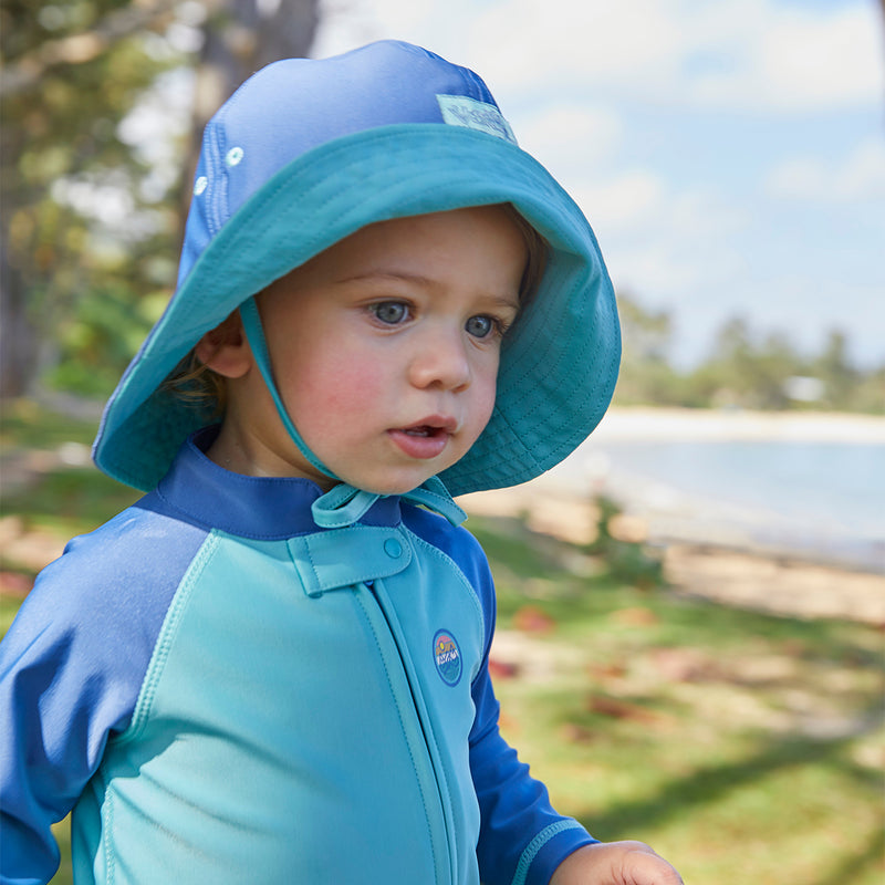 Baby boy in a sun hat on the beach|tropical-cascade