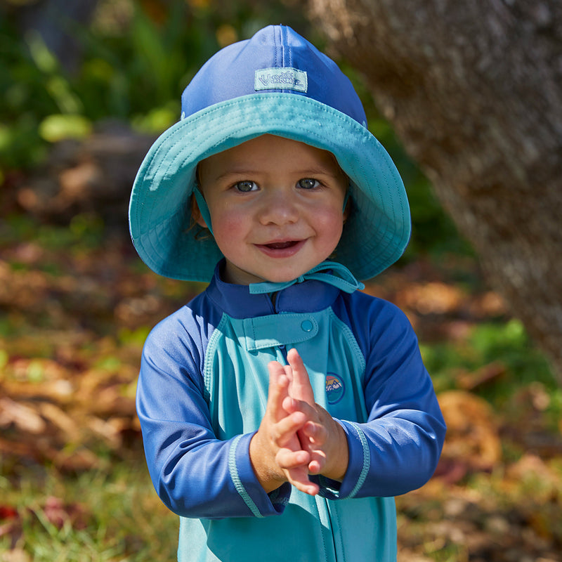 Baby boy in the baby boy's sun hat in washed navy river|washed-navy-river