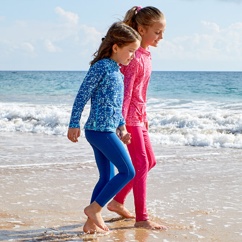 girls playing on the beach in UV Skinz's swim leggings|navy-blue