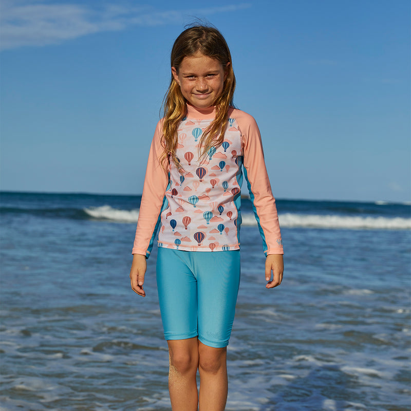 Girl in the ocean in UV Skinz's girl's swim shorts in lagoon|lagoon