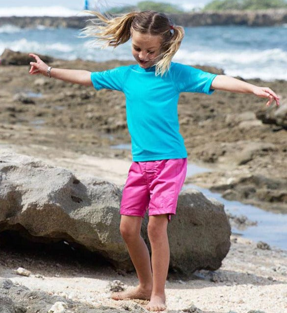Little girl in the girl's board shorts in bubblegum|bubblegum