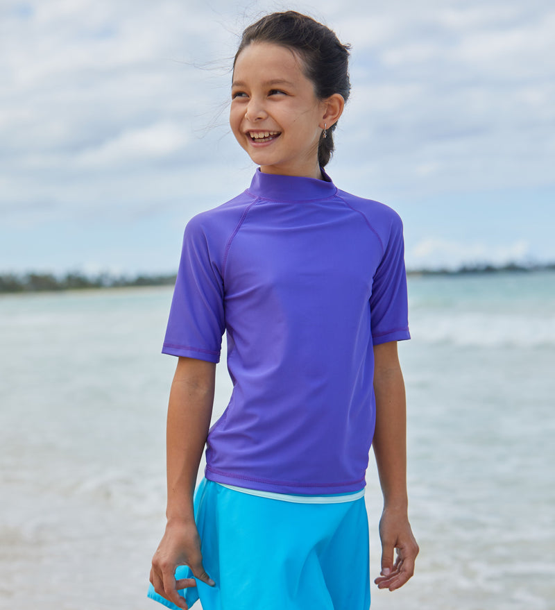 Young girl in the kid's short sleeve swim shirt in purple|purple