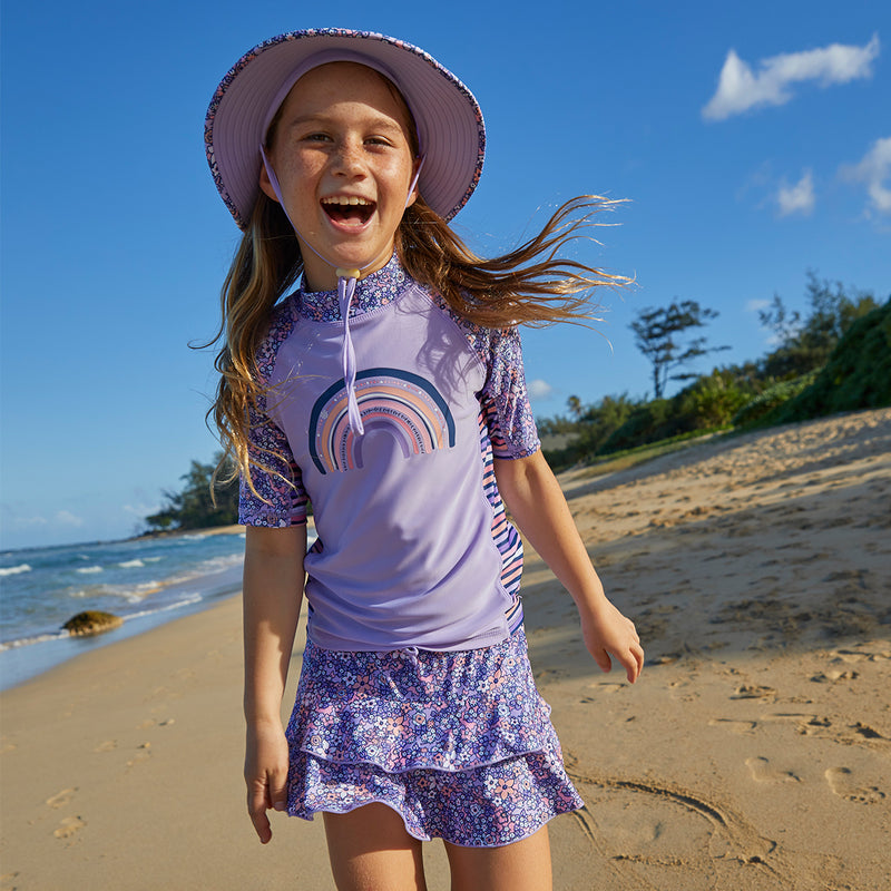 Little girl wearing UV Skinz's girl's short sleeve sunny swim shirt in lavender fields|lavender-fields