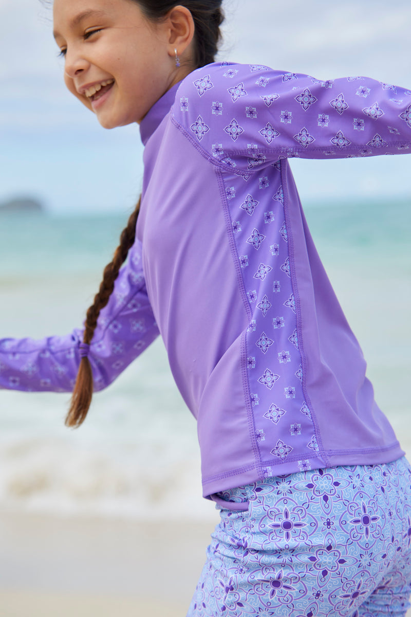 Girl playing in the girl's long sleeve UPF swim shirt in purple mini medallion|purple-mini-medallion