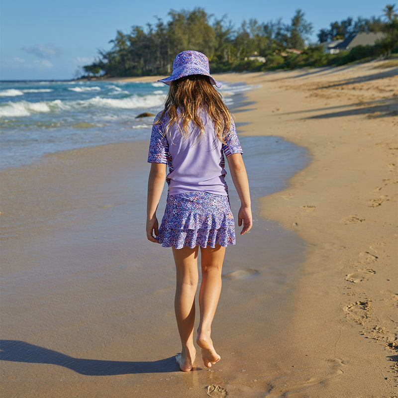 Girl on the beach in UV Skinz's girls swim skirt in lavender fields|lavender-fields