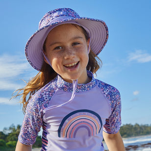 Little girl on the beach in UV Skinz's girl's swim hat in lavender fields|lavender-fields