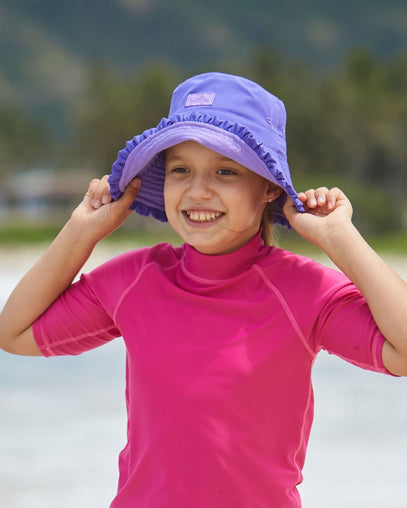 Girl wearing UV Skinz's girls bucket hat in purple misty purple|purple-misty-purple