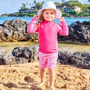 Little girl in UV Skinz's ribbon hat in white|white