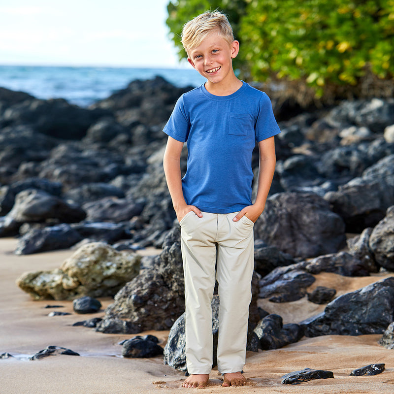 Boy near the rocks at the beach in UV Skinz's boy's everyday UPF tee|white
