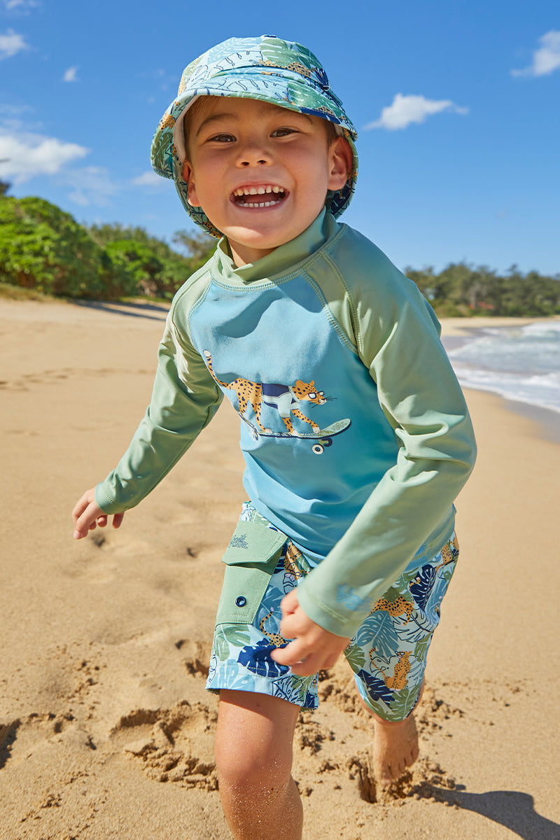 Little boy wearing UV Skinz's boy's long sleeve active swim shirt in sage cool cat|sage-cool-cat