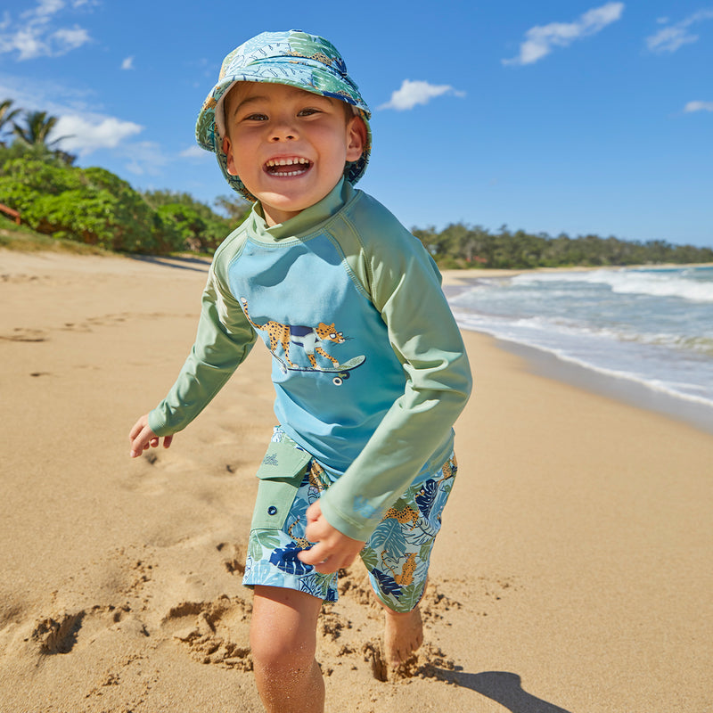 Little Boy Playing in the Sand in UV Skinz's Boy's Classic Board Shorts|stained-glass