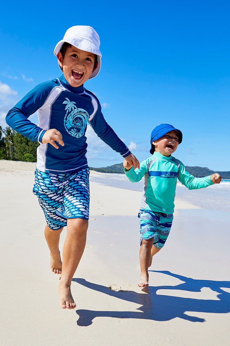 Little boy playing wearing the boy's long sleeve active swim shirt in midnight ombre wave|midnight-ombre-wave