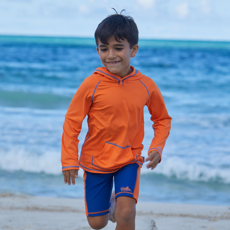 Young boy in UV Skinz's boy's pullover hoodie in orange|orange