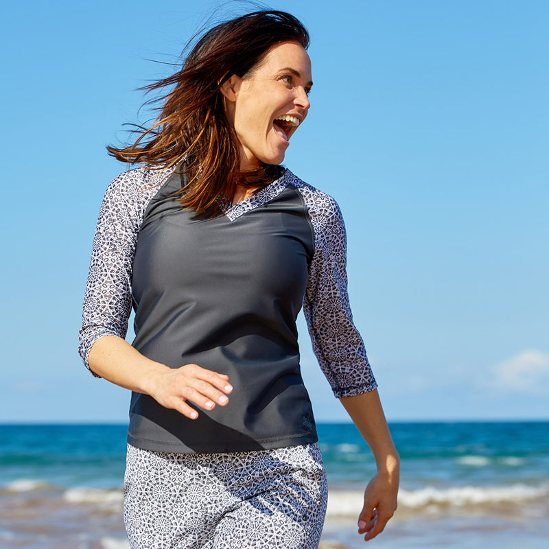 Woman in a UPF swim shirt by UV Skinz|teal-kaleidoscope