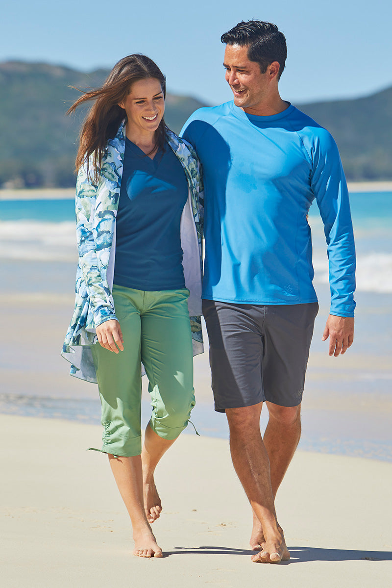 Woman Walking with Her Husband on the Beach in UV Skinz's Women's V-Neck Sun & Swim Shirt in MIdnight|midnight