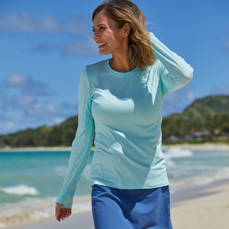 Woman Laughing on the Beach in UV Skinz's Women's Long Sleeve Everyday Tee in Beach Glass|beach-glass