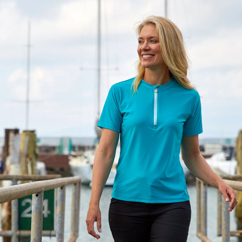 Woman wearing UV Skinz's women's quarter zip crew swim shirt|navy-blue