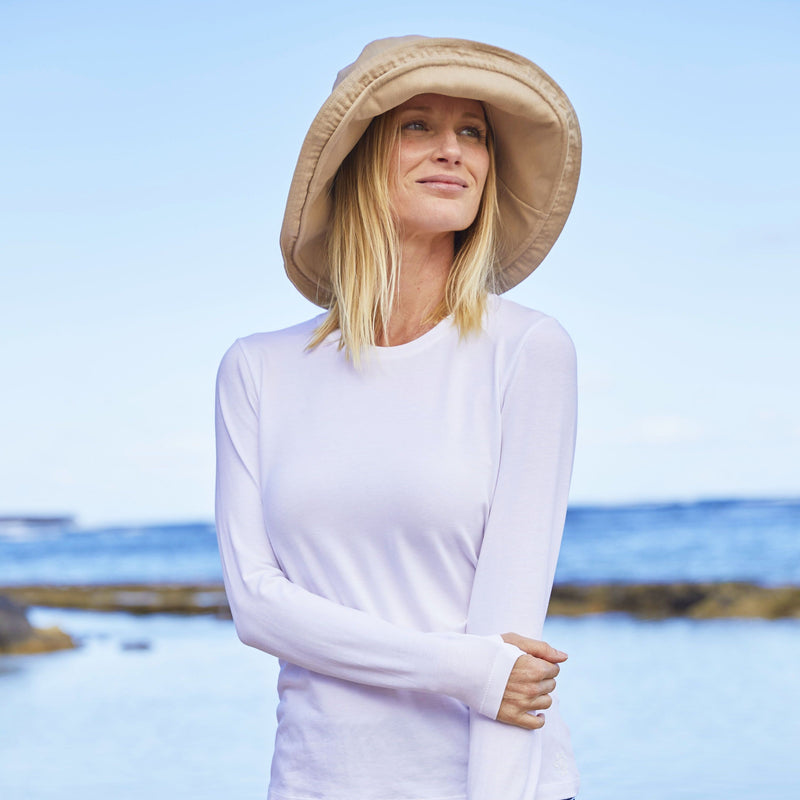 woman in UV Skinz's wide brim sun hat in sandcastle|sandcastle