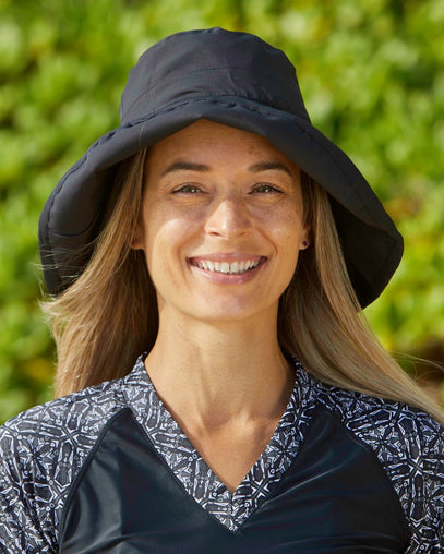 Woman in UV Skinz's Women's Rolled Brim Hat|black