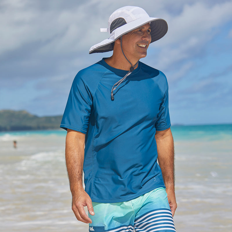 Man walking down the beach in UV Skinz's short sleeve swim shirt|midnight