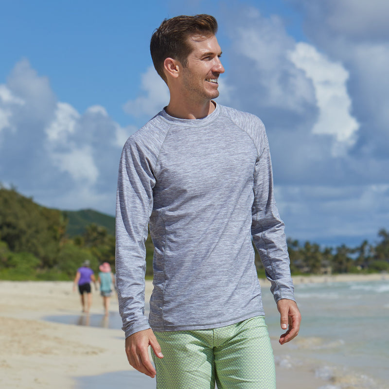 Man on the beach in UV Skinz's men's long sleeve crew swim shirt in cool grey jaspe|cool-grey-jaspe