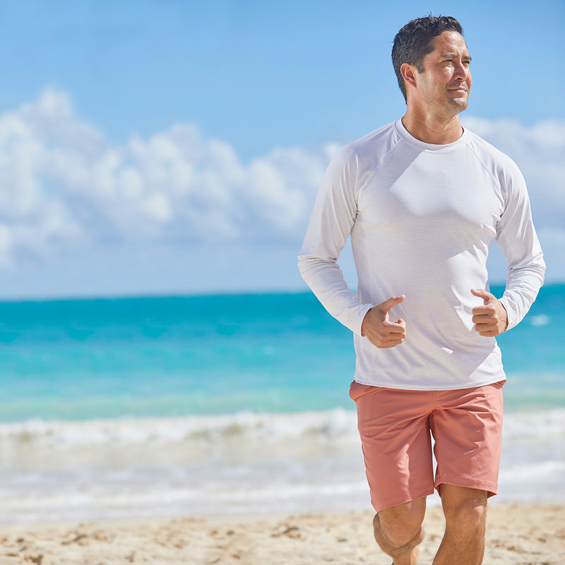 Man running on the beach in men's long sleeve crew swim shirt in white jaspe|white-jaspe