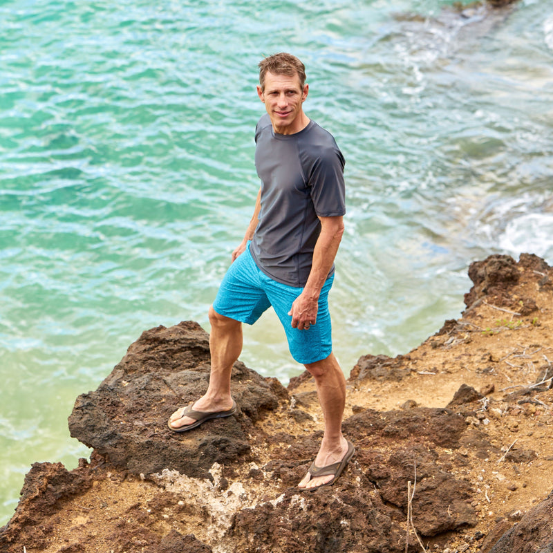 man wearing UV Skinz's men's classic trunks in caribbean swirls|caribbean-swirls