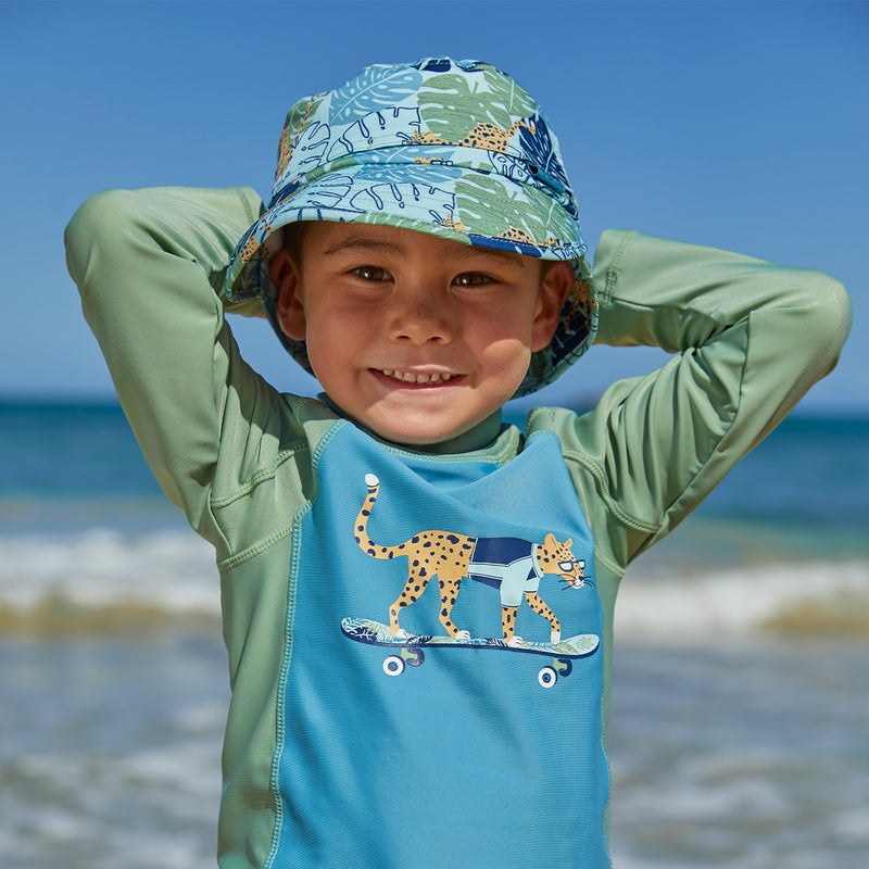 Little boy in UV Skinz's kid's adjustable flap sun hat in cool cat|cool-cat