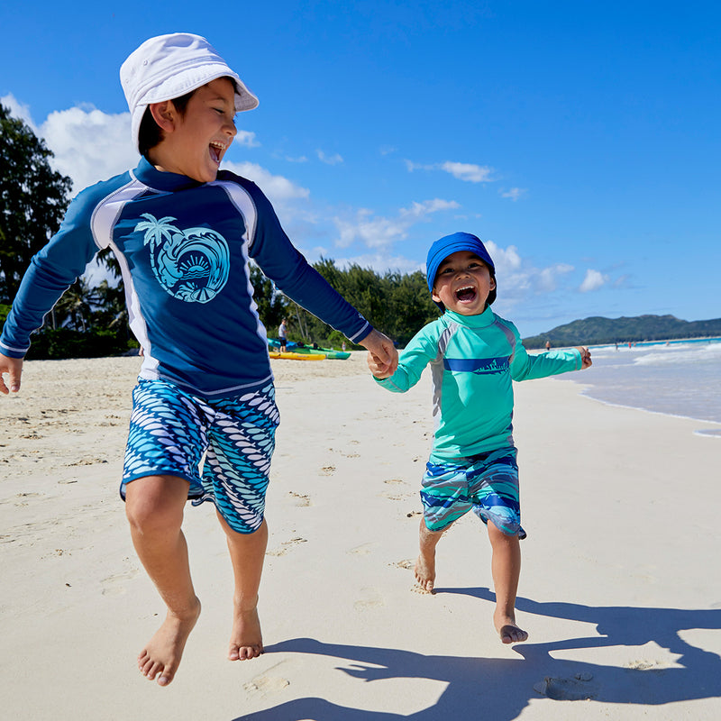 Kids playing in UV Skinz's kid's adjustable flap sun hats|deep-sea