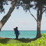 Woman walking to the beach in UV Skinz's women's beach cover up in mykonos blue
