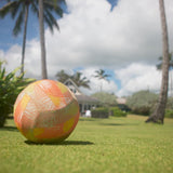 Kid playing with a ball outside in UV Skinz's kid's long sleeve swim shirt 