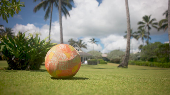 Kid playing with a ball outside in UV Skinz's kid's long sleeve swim shirt 