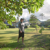 Man in UV Skinz's men's long sleeve active swim shirt walking on the beach