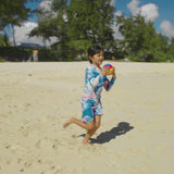 Girls on the beach in UV Skinz's UV Skinz's girls long sleeve rash guard