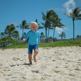 Little boy in UV Skinz's boy's swim shorts