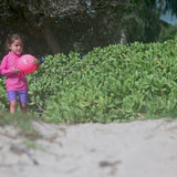 Girl playing in UV Skinz's girl's swim shorts