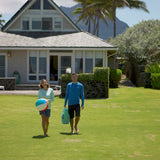 Woman in UV Skinz's Women's Long Sleeve Everyday Tee on the Beach with Her Husband