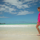 Girl on the beach in UV Skinz's girls pullover hoodie 