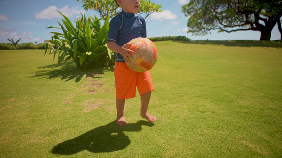 Little boy playing in UV Skinz's Kid's short sleeve swim shirt 
