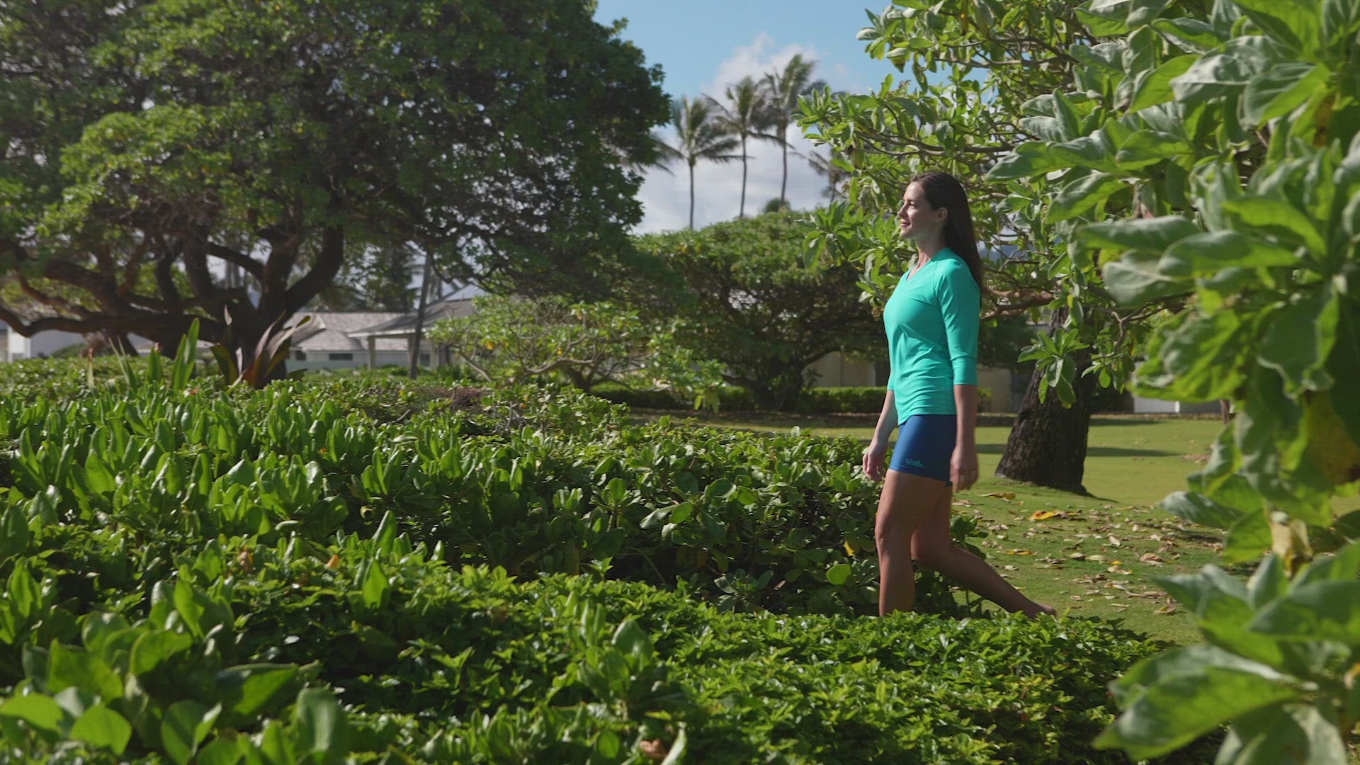 Woman Walking on the Beach in UV Skinz's Women's Active Swim Shorts