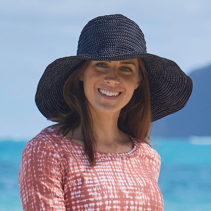 Woman in UV Skinz's wide brim UP 50+ hat|navy
