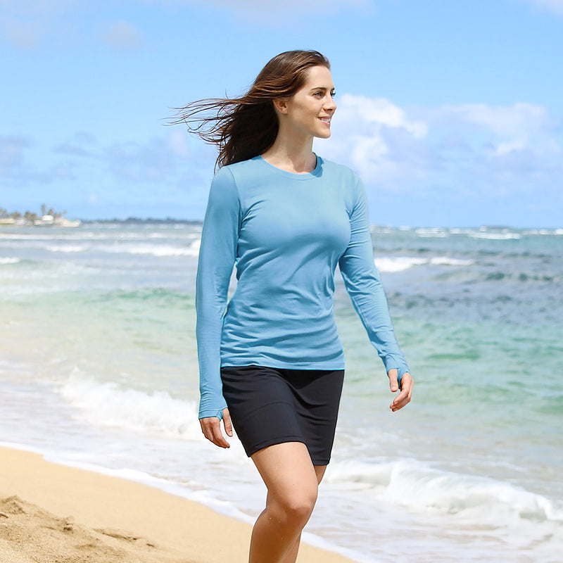 Woman on the Beach in UV Skinz's Women's Long Sleeve Everyday Tee in lagoon|lagoon