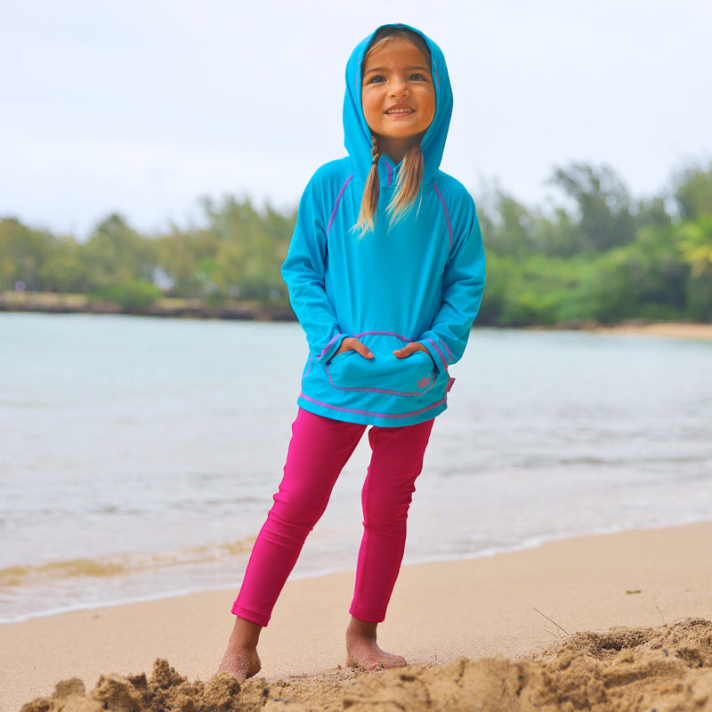 Little girl wearing UV Skinz's girls pullover hoodie in aqua|aqua
