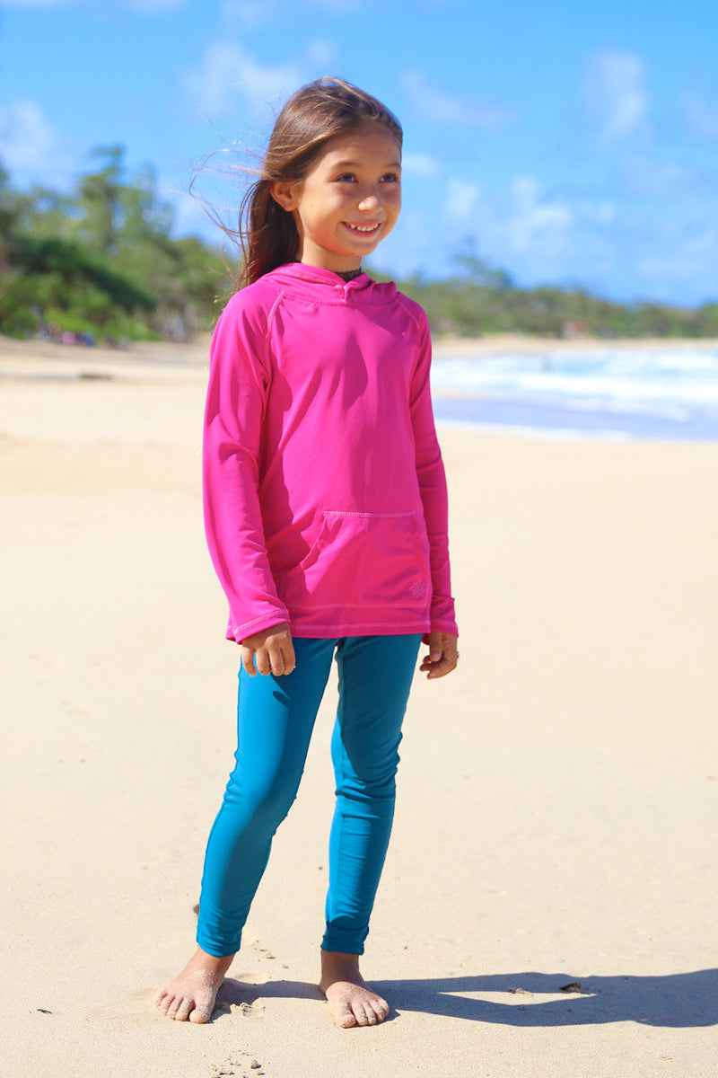 Little girl on the beach in UV Skinz's swim tights|dark-teal