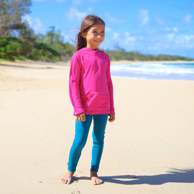 Little girl on the beach in UV Skinz's swim tights|dark-teal
