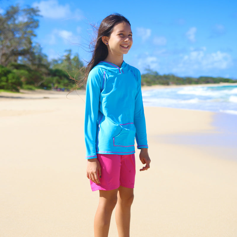 Little girl wearing the girl's board shorts in hot pink|hot-pink
