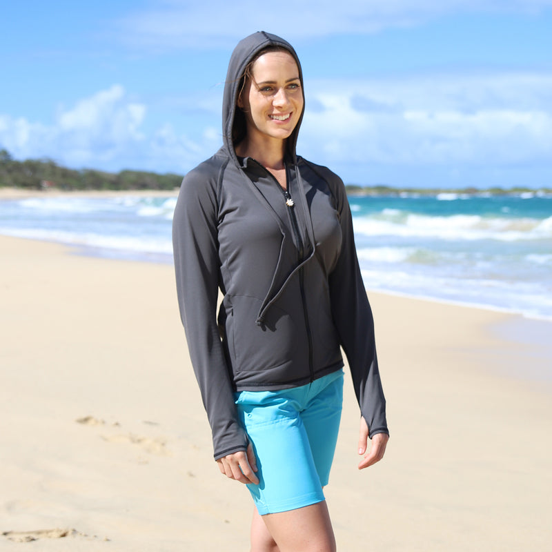 Woman in UV Skinz's women's hooded water jacket in charcoal|charcoal