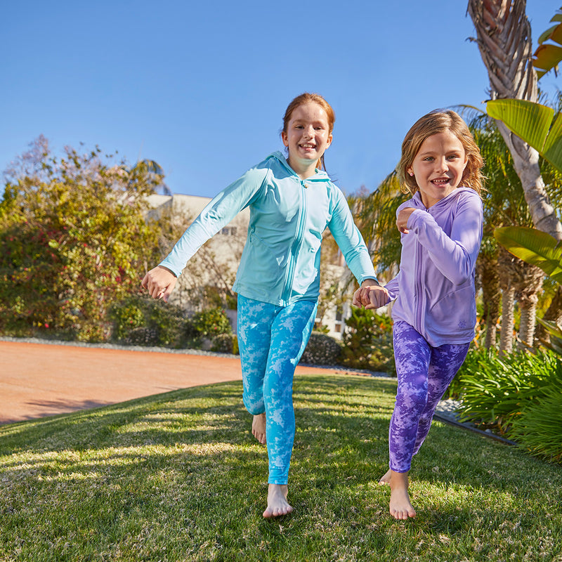 girl running in UV Skinz's swim tights in aqua tie dye|aqua-tie-dye