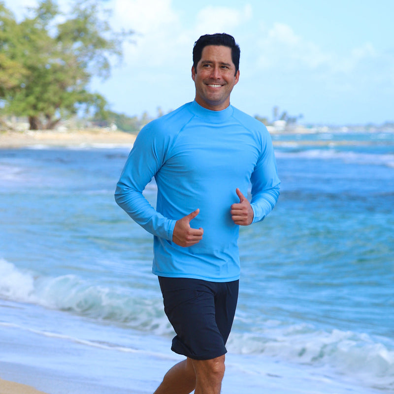 Man running on the beach in UV Skinz's men's long sleeve swim shirt in regatta|regatta