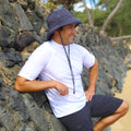 Man wearing UV Skinz's men's bucket hat with drawstring in charcoal grey|charcoal-grey